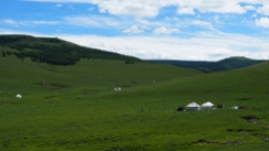 Occasional mongol yurts scattered along the hill side.